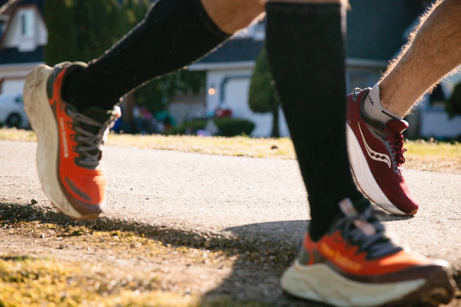Close-up of running shoes in motion on a dirt path during outdoor exercise.