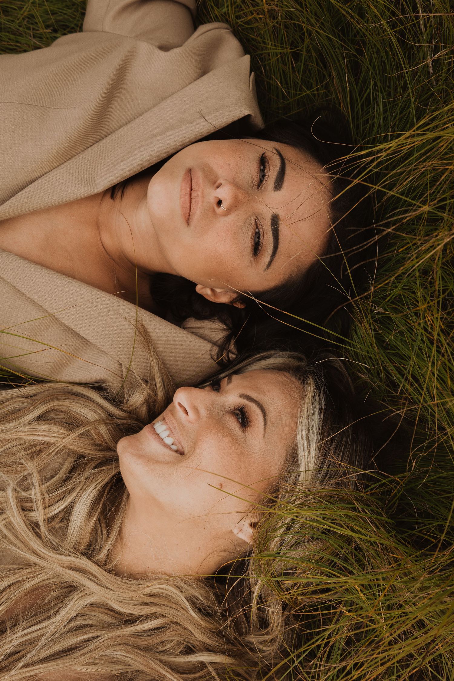 A series of artistic portrait photos showing someone lying in tall grass with natural lighting and warm tones.