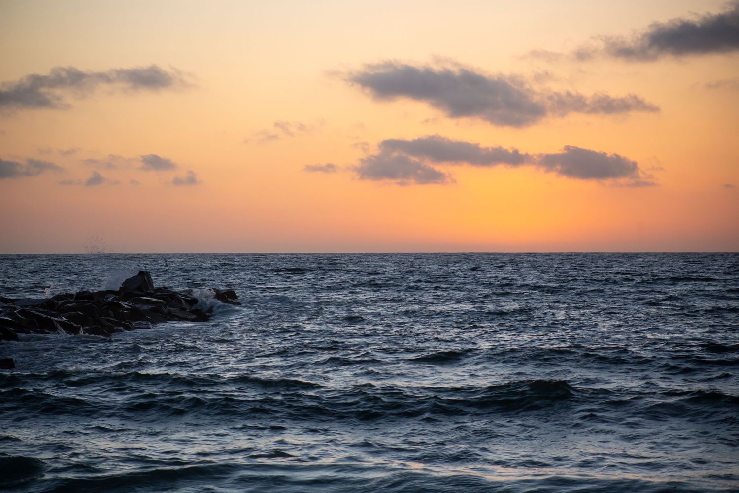 A series of ocean horizon views at sunset showing the progression from golden hour to dusk over the water.