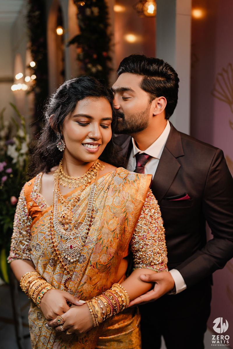 Romantic couple portrait with traditional Indian bridal jewelry and formal attire.