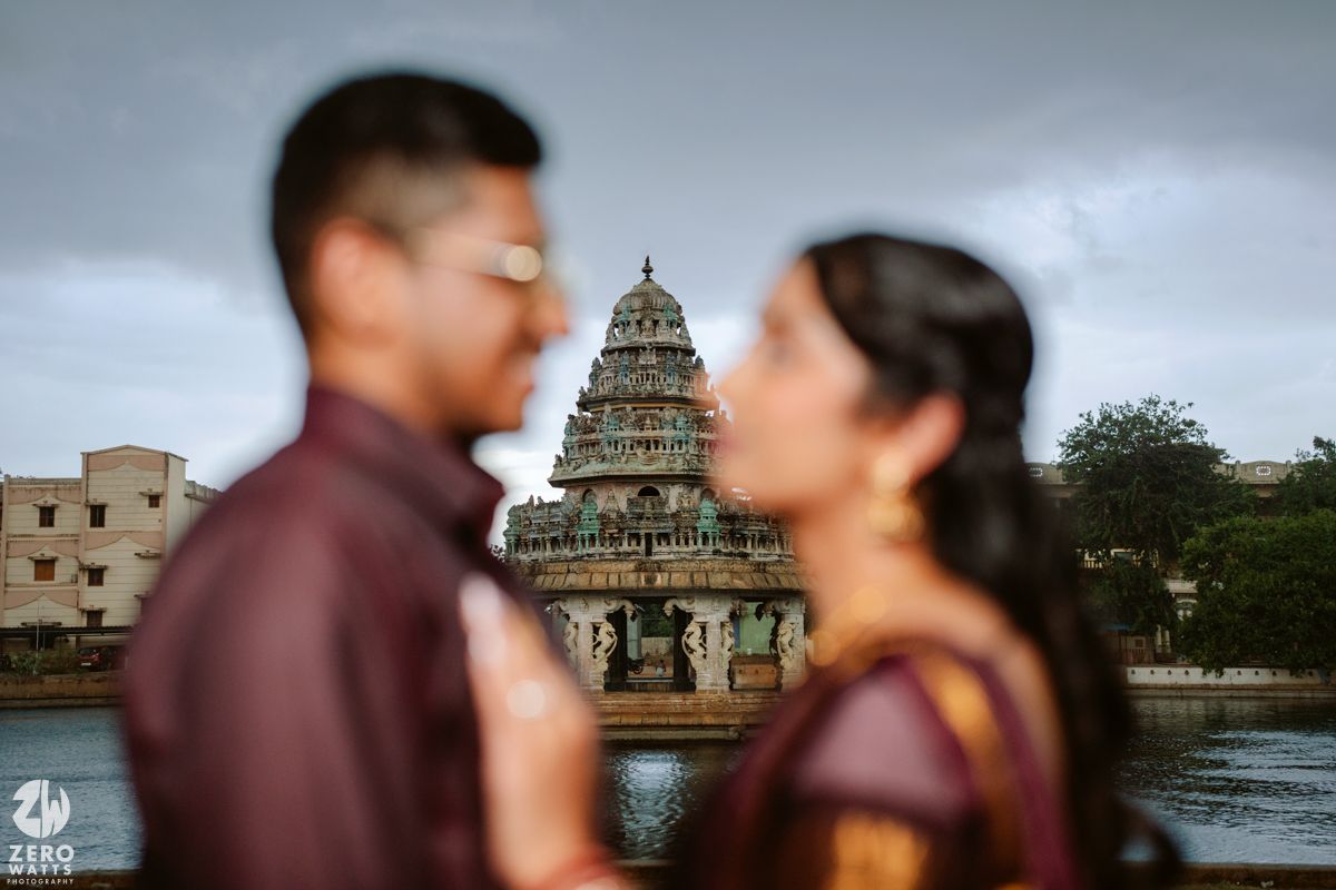 Temple architecture forms a dramatic backdrop for a couple's portrait session at dusk.