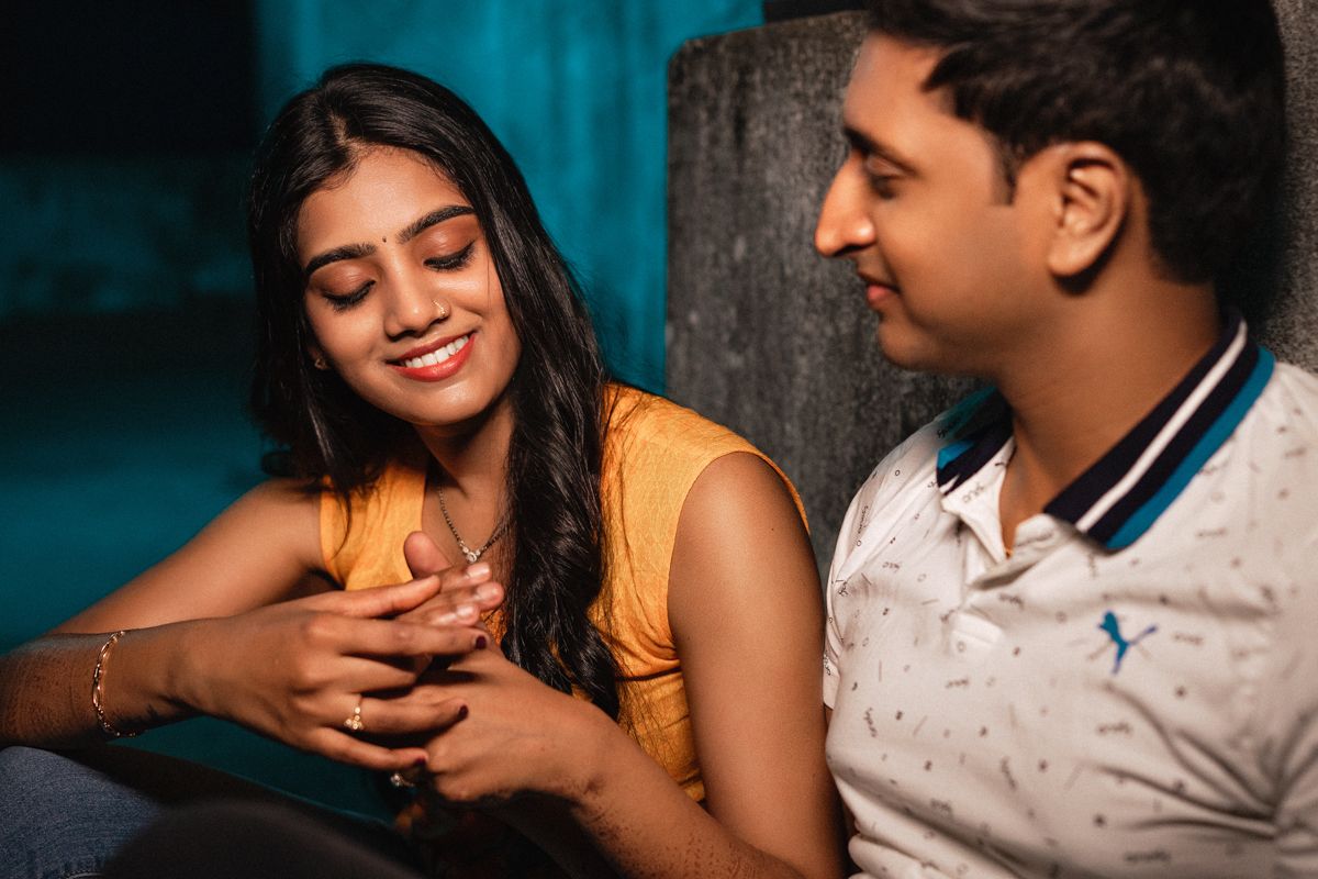 Romantic couple sharing tender moments against a dark blue background.