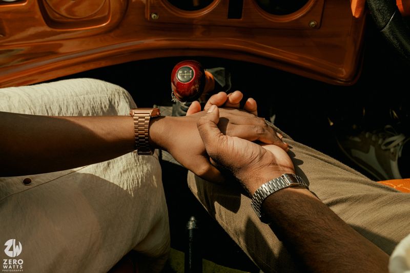 Close-up shot of hands holding each other with a romantic vintage aesthetic.