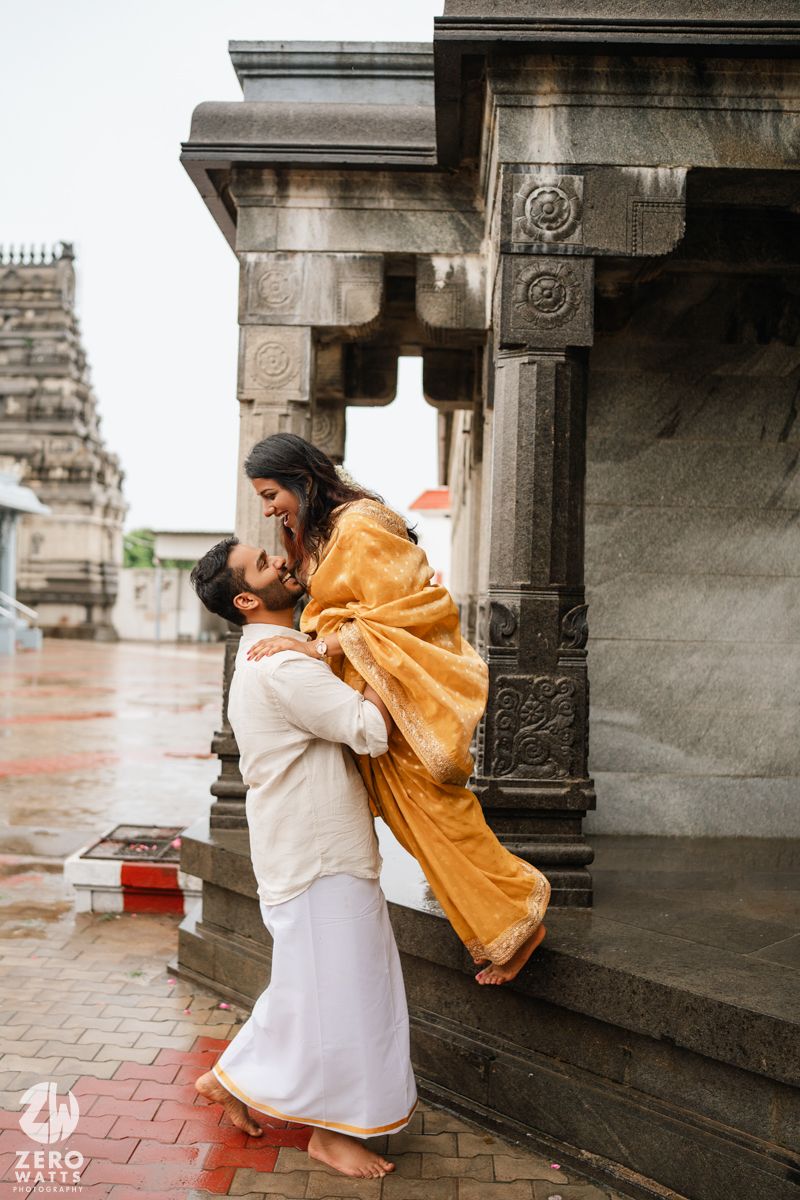 A series of three photos showing a person in white clothing interacting with yellow fabric in a temple colonnade.