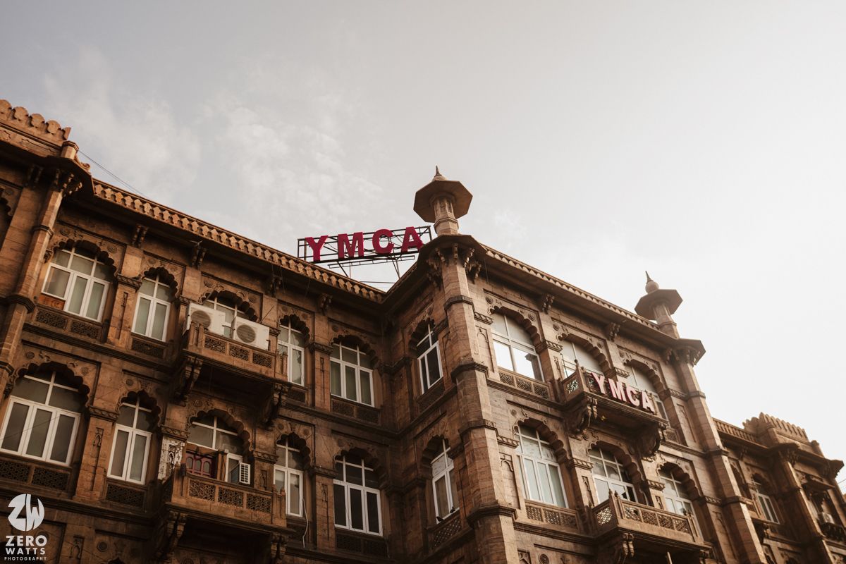 Historic colonial building facade with ornate architectural details in sepia tones.