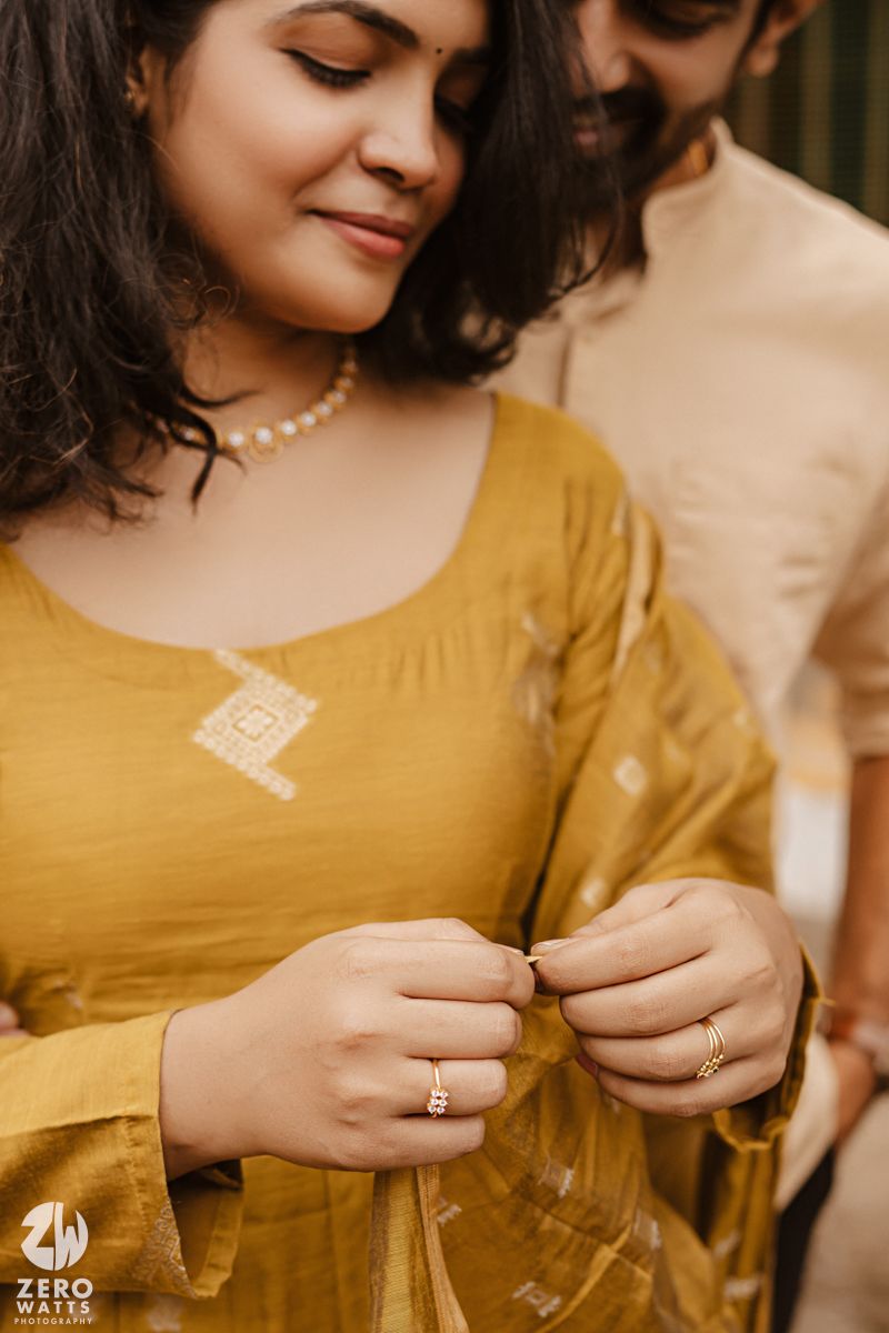 Close-up shots of hands wearing traditional jewelry against mustard yellow fabric in sepia tones.