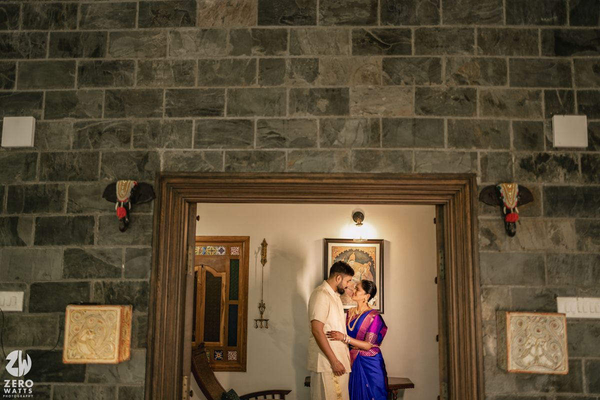 A stone wall interior with framed artwork displayed along a hallway.