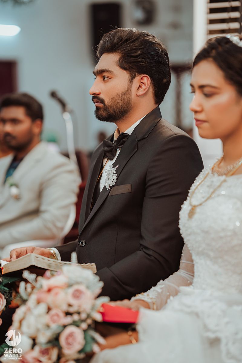 Wedding ceremony scene with beautiful floral arrangements and formal attire.