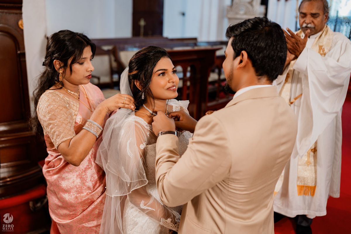 A candid moment during wedding preparations showing a tender interaction in a church setting.