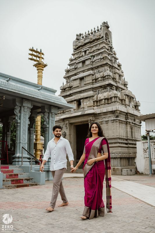 Romantic photoshoot at a Hindu temple featuring traditional architecture and intricate stone carvings.