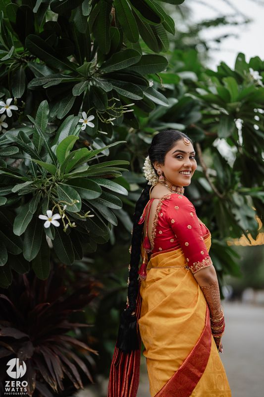 A series of photos showing traditional South Indian wedding attire featuring a yellow silk saree with red blouse against lush foliage.