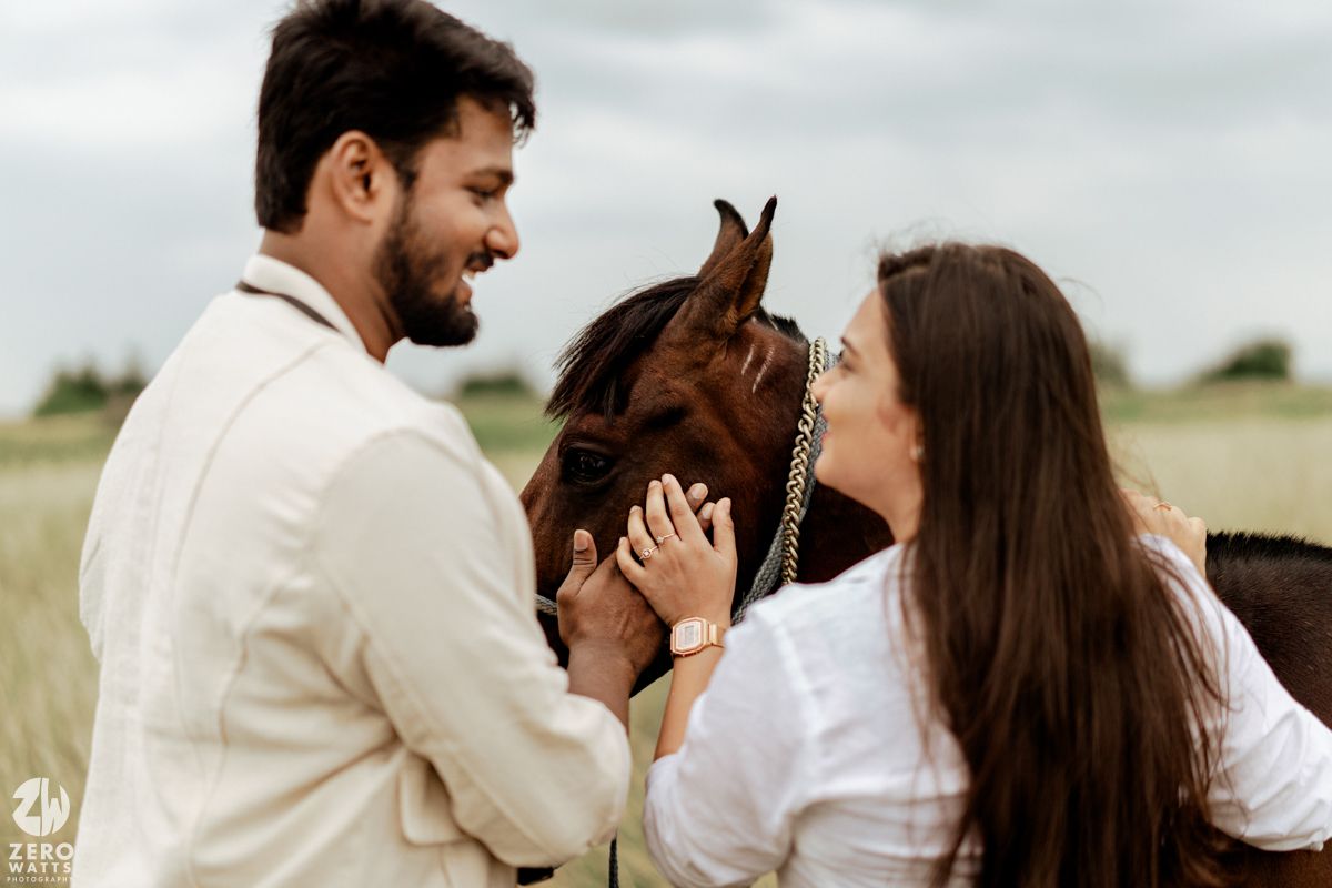 Intimate moments shared between a couple and their horse in a natural meadow setting.