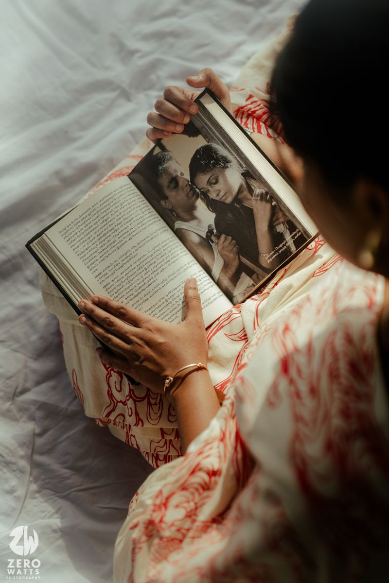 Person in white and red clothing reads a book while lying on white bedding, shown from multiple angles.
