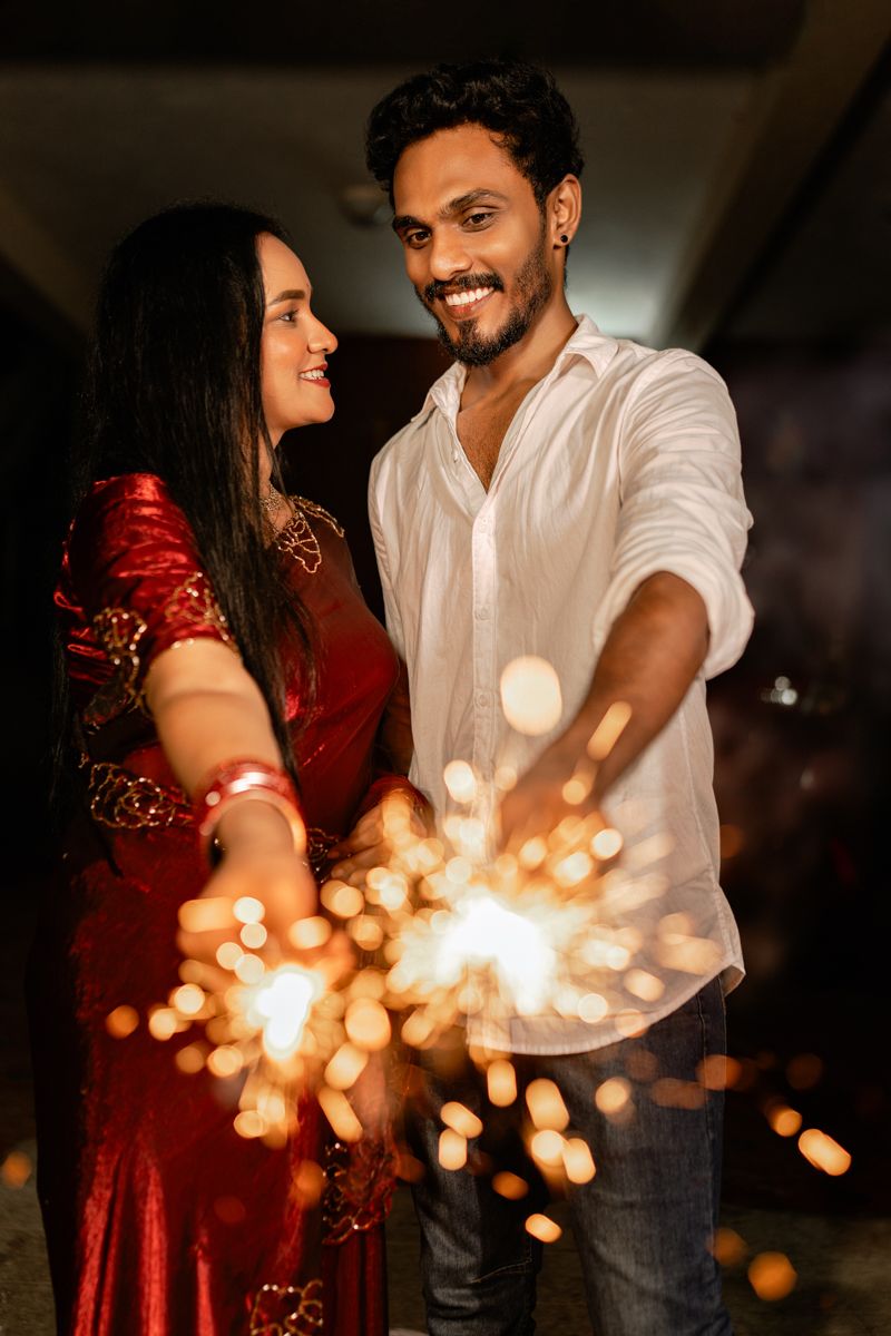 A romantic moment with sparklers creating magical bokeh lights in the evening.