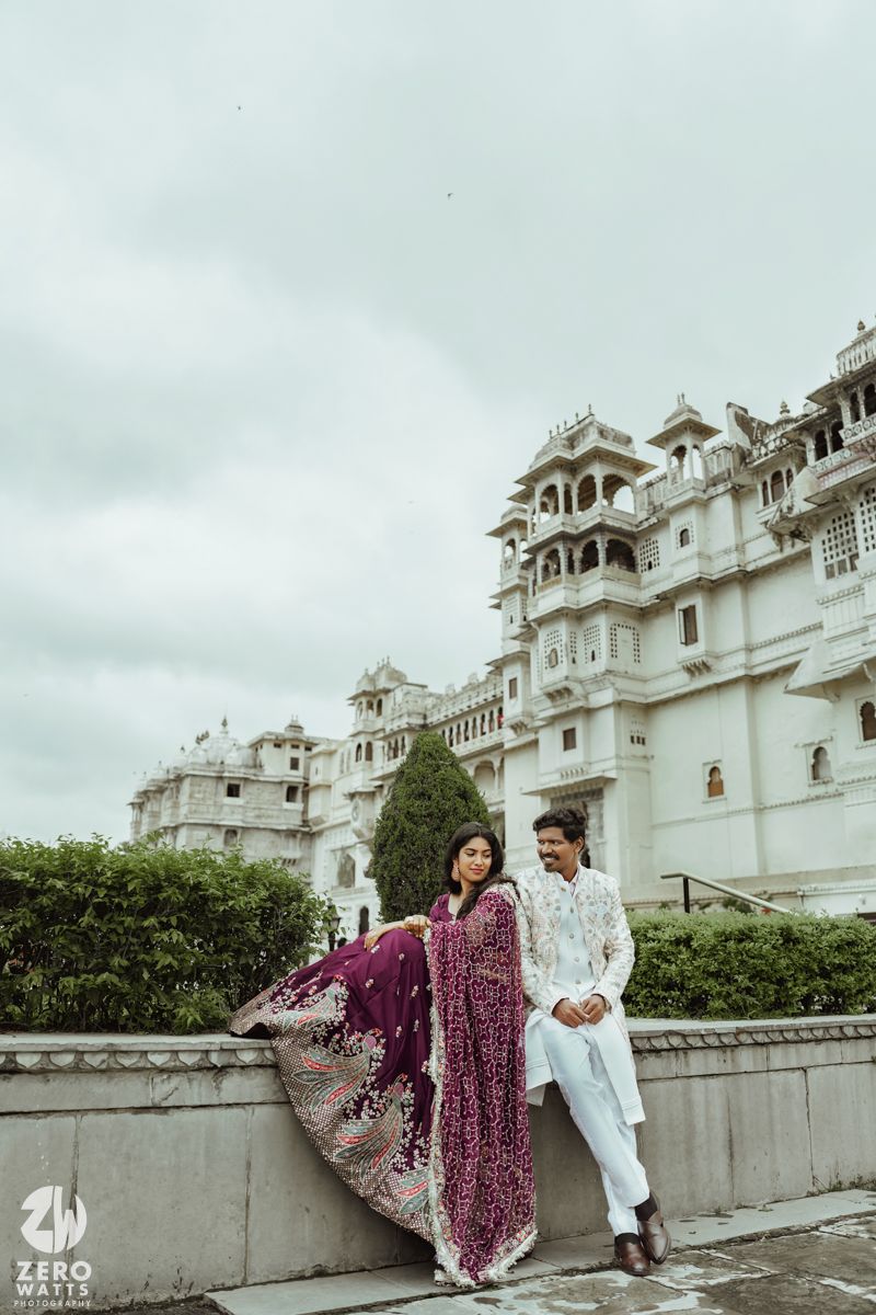 Romantic photoshoot at Udaipur City Palace with couple in traditional Indian wedding attire.