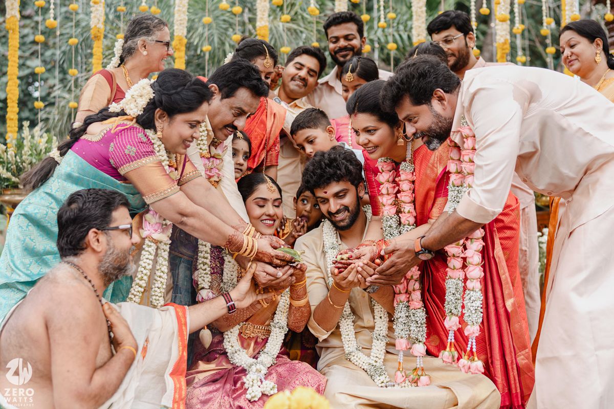 Joyful celebration at a traditional Indian wedding ceremony with vibrant decorations and yellow marigold garlands.