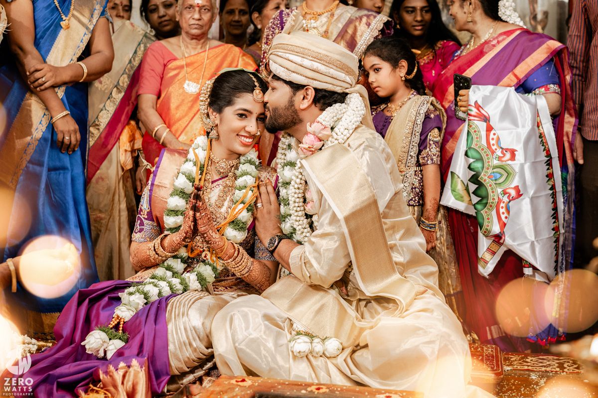 Festive Indian wedding celebration with guests in traditional attire during ceremony rituals.