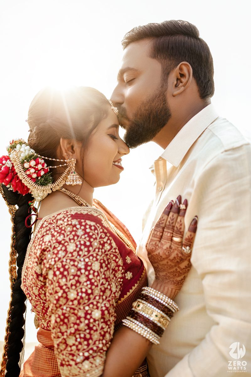 Couple in traditional Indian wedding attire share intimate moments during sunset photoshoot.