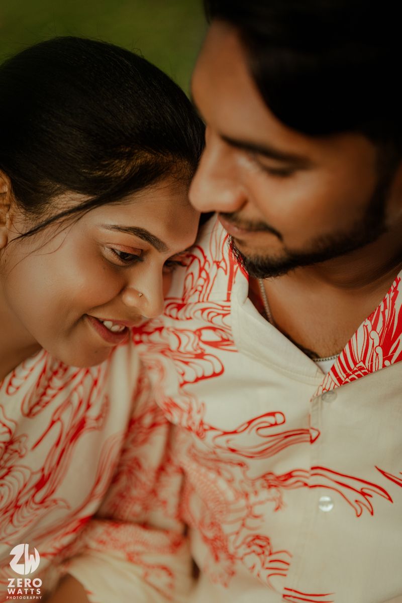 An intimate close-up moment captured against a white and red patterned fabric background.
