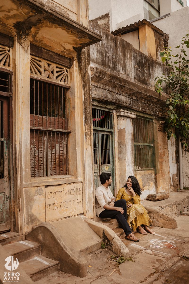 A romantic photoshoot on old building steps featuring vintage architecture and weathered walls.