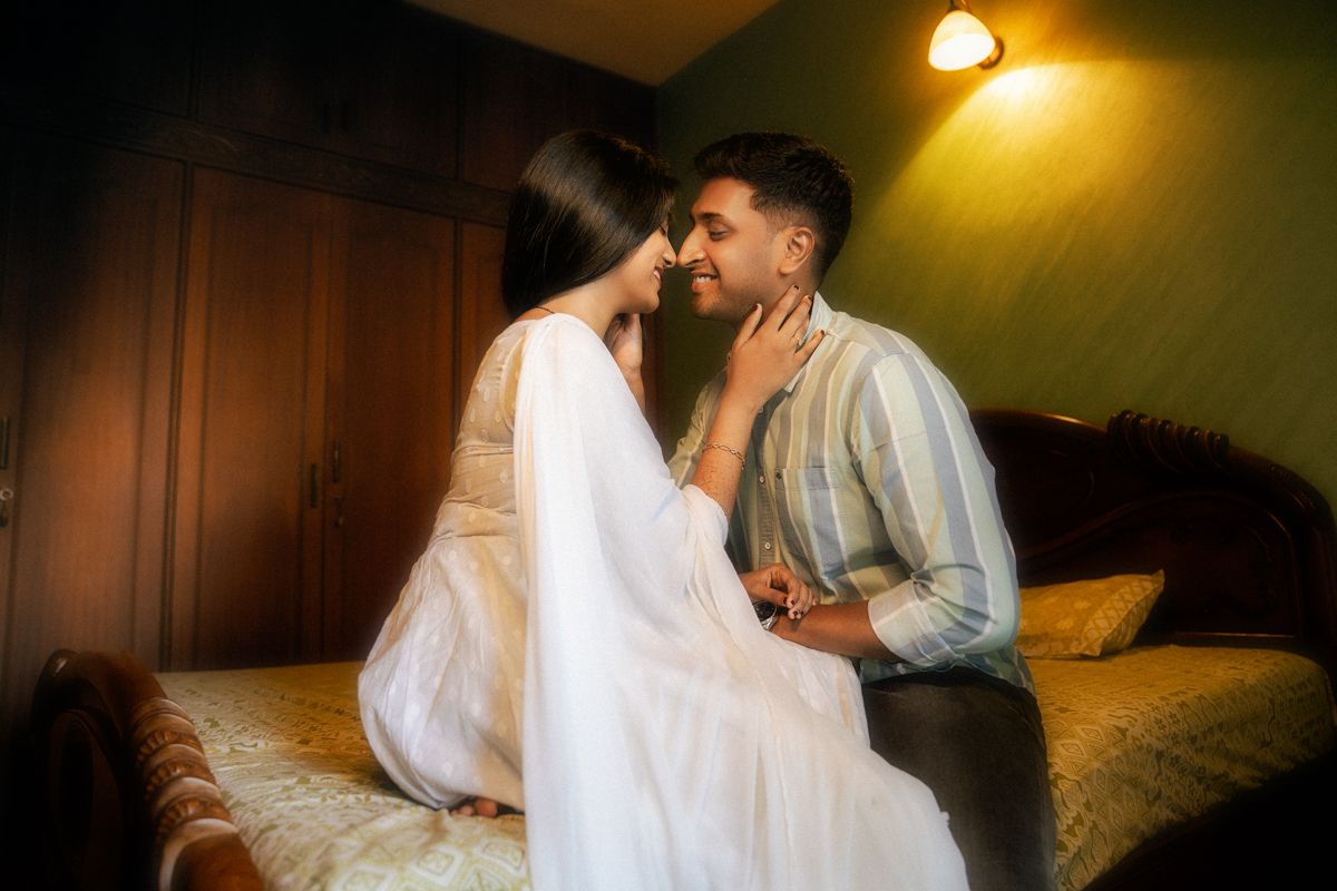 Atmospheric indoor portrait of a couple in intimate embrace.