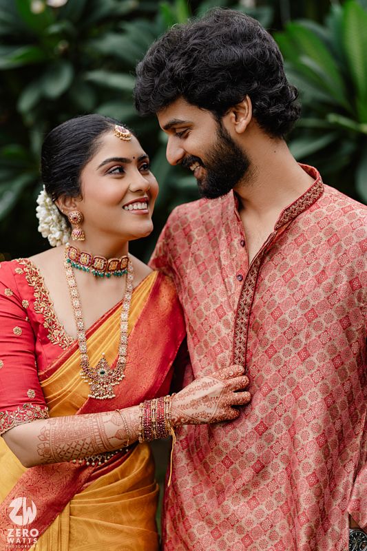 A romantic couple in traditional South Indian attire share intimate moments during a wedding photoshoot.