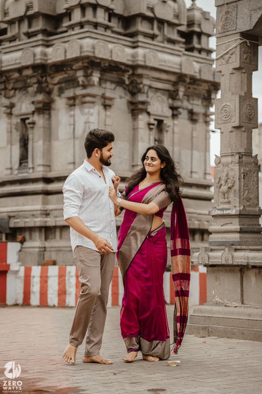 Traditional temple architecture forms backdrop for romantic photoshoot in cultural setting.