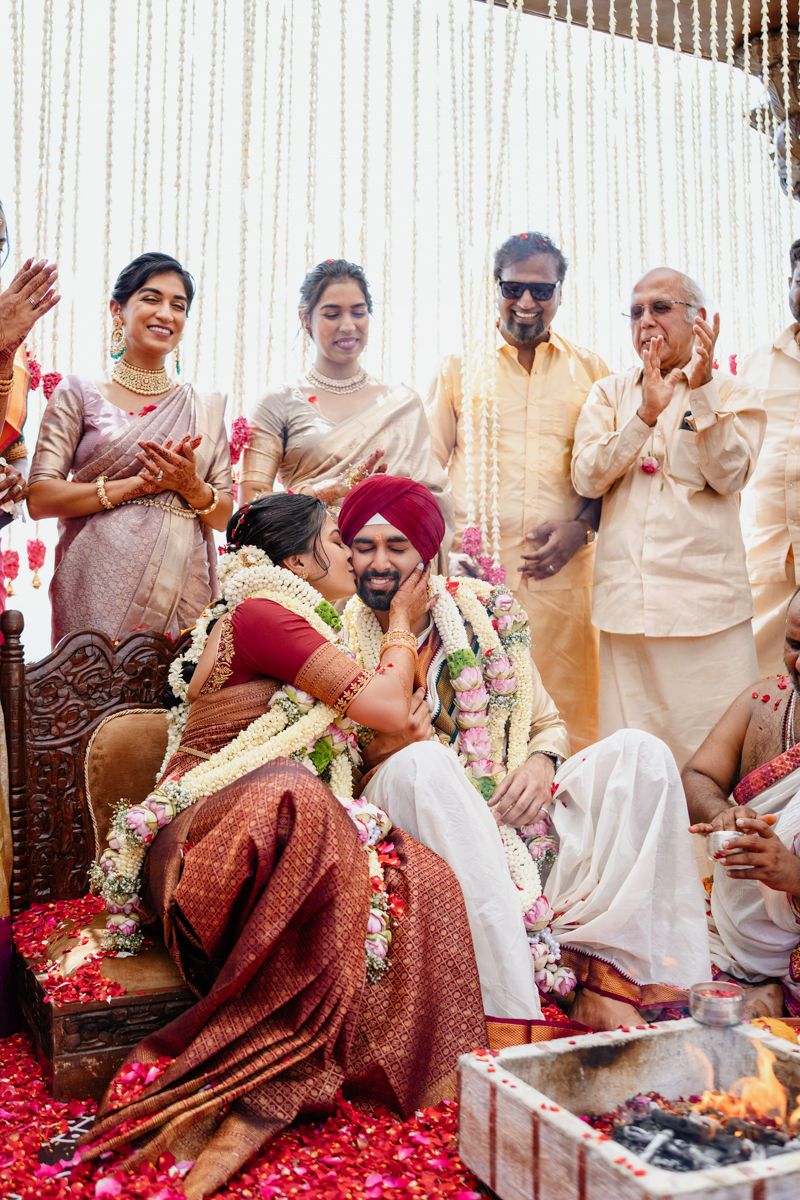 Traditional Indian wedding ceremony with guests seated around a sacred fire during religious rituals and customs.