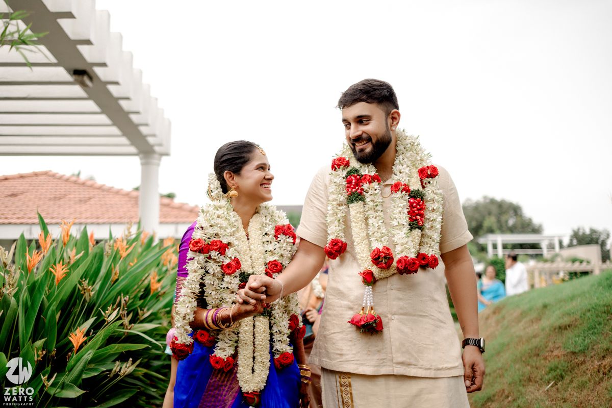 Traditional wedding ceremony with floral garlands and decorations in an outdoor setting.