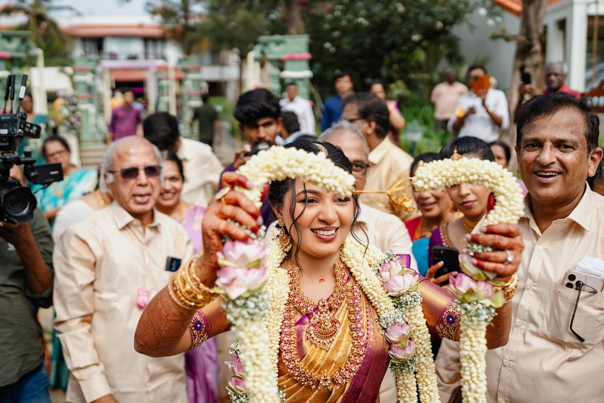 Wedding guests celebrate during a traditional Indian ceremony with festive attire and decorations.