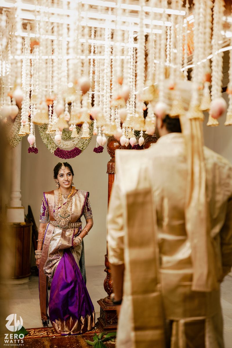 Luxurious wedding decor featuring crystal chandeliers and traditional Indian floral arrangements.