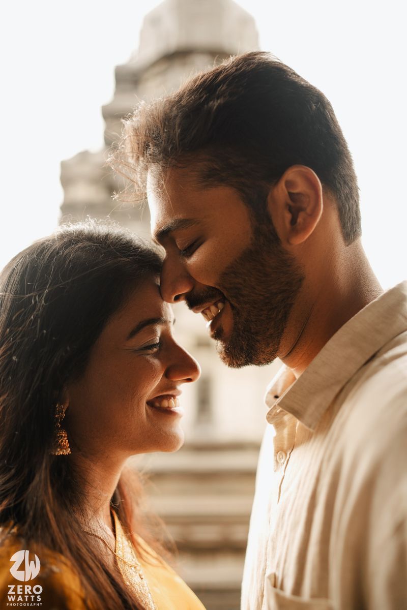 A romantic couple shares intimate moments in a series of warm, backlit photographs against an architectural backdrop.