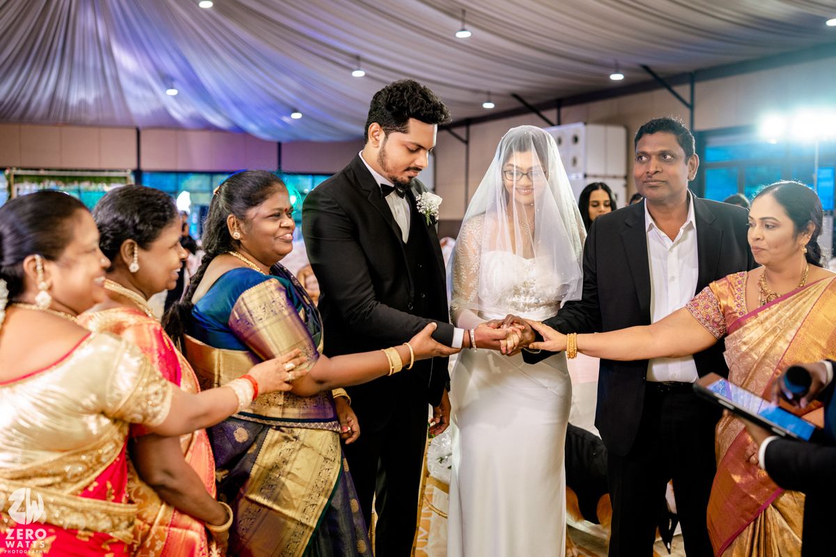 Wedding guests participate in traditional Indian dance celebrations at a vibrant reception party.