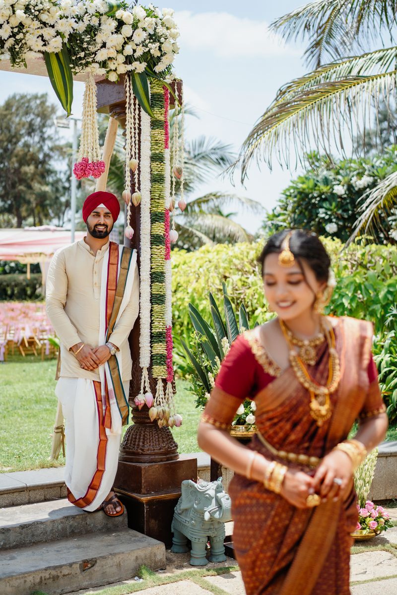 Outdoor Indian wedding photography session with tropical garden backdrop.