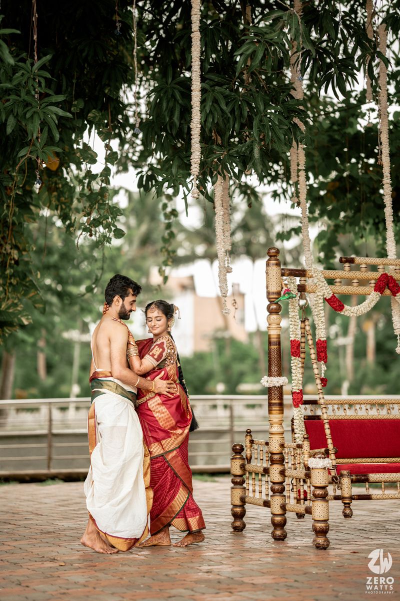 Candid moments during a South Indian wedding ceremony with traditional decor and wooden pillars in background.