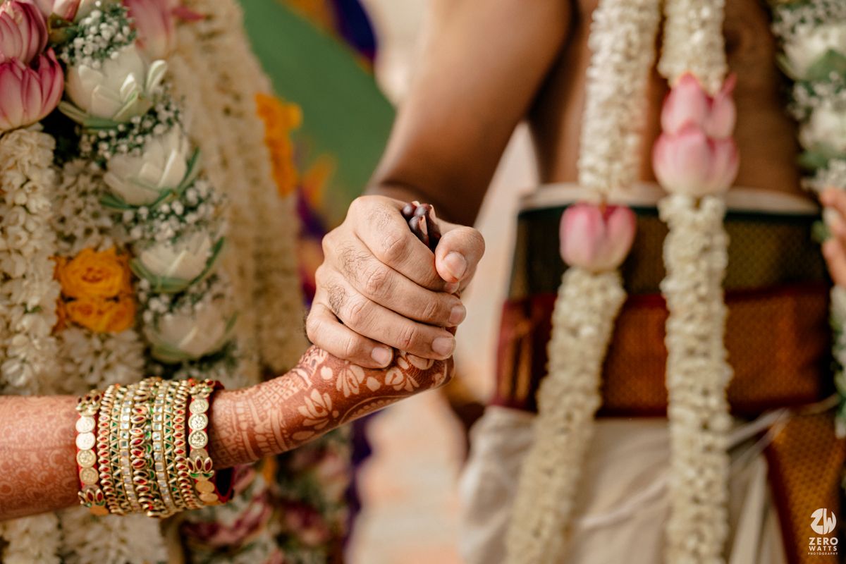 Close-up detail of traditional Indian wedding jewelry and bangles adorned with intricate designs and embellishments.