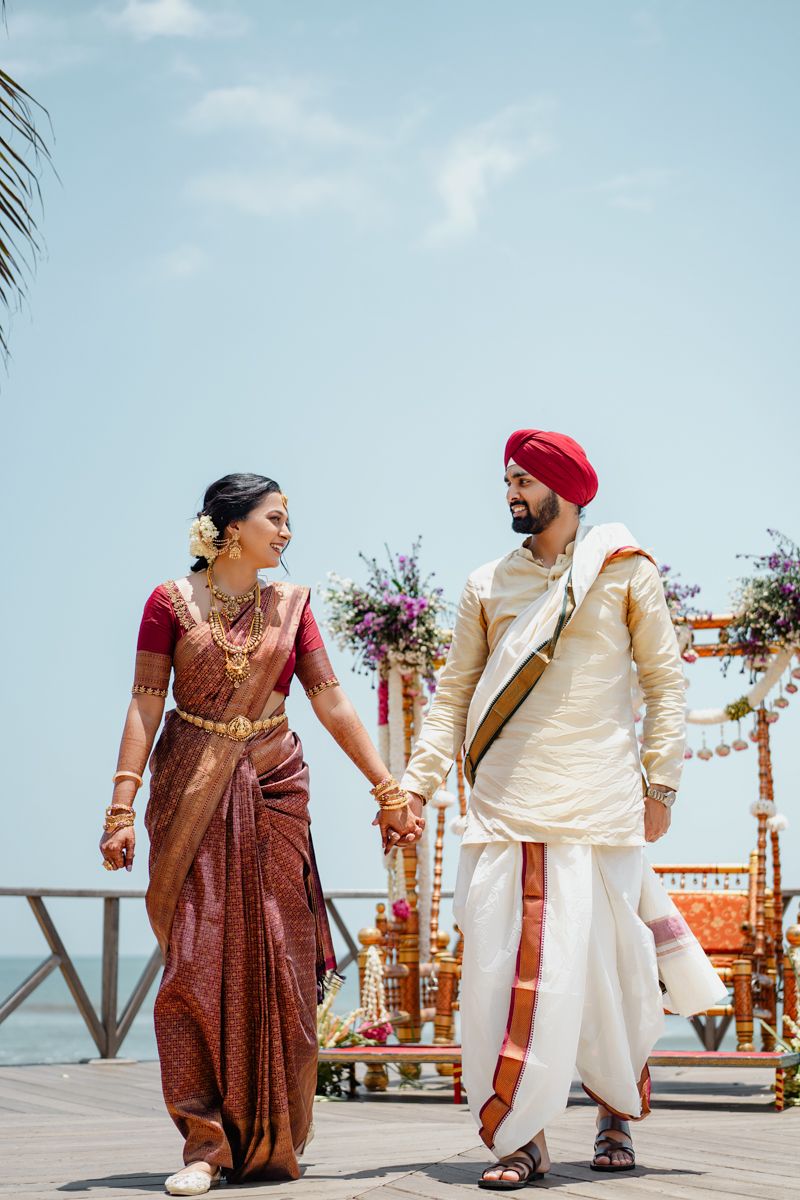 Candid wedding moments captured on a beachfront wooden deck with ocean backdrop.