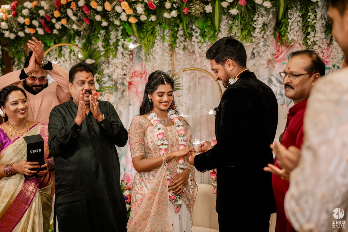 Wedding celebration with floral decor and festive atmosphere as guests gather at an elegant reception venue.