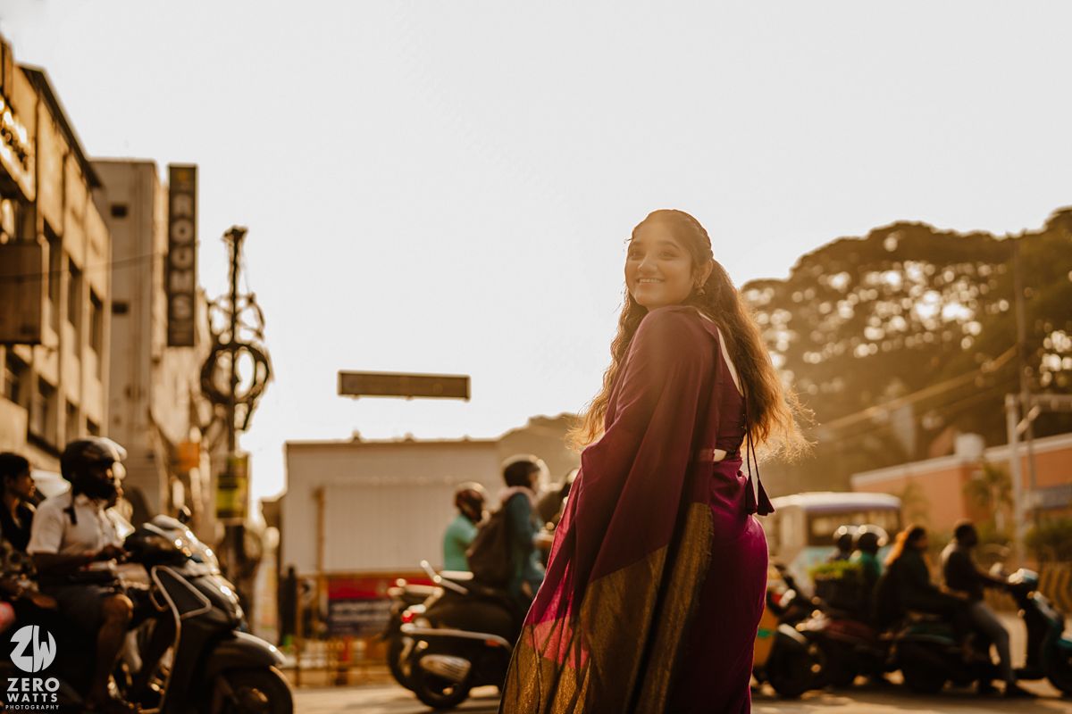Romantic sunset photoshoot with urban architecture and warm lighting.