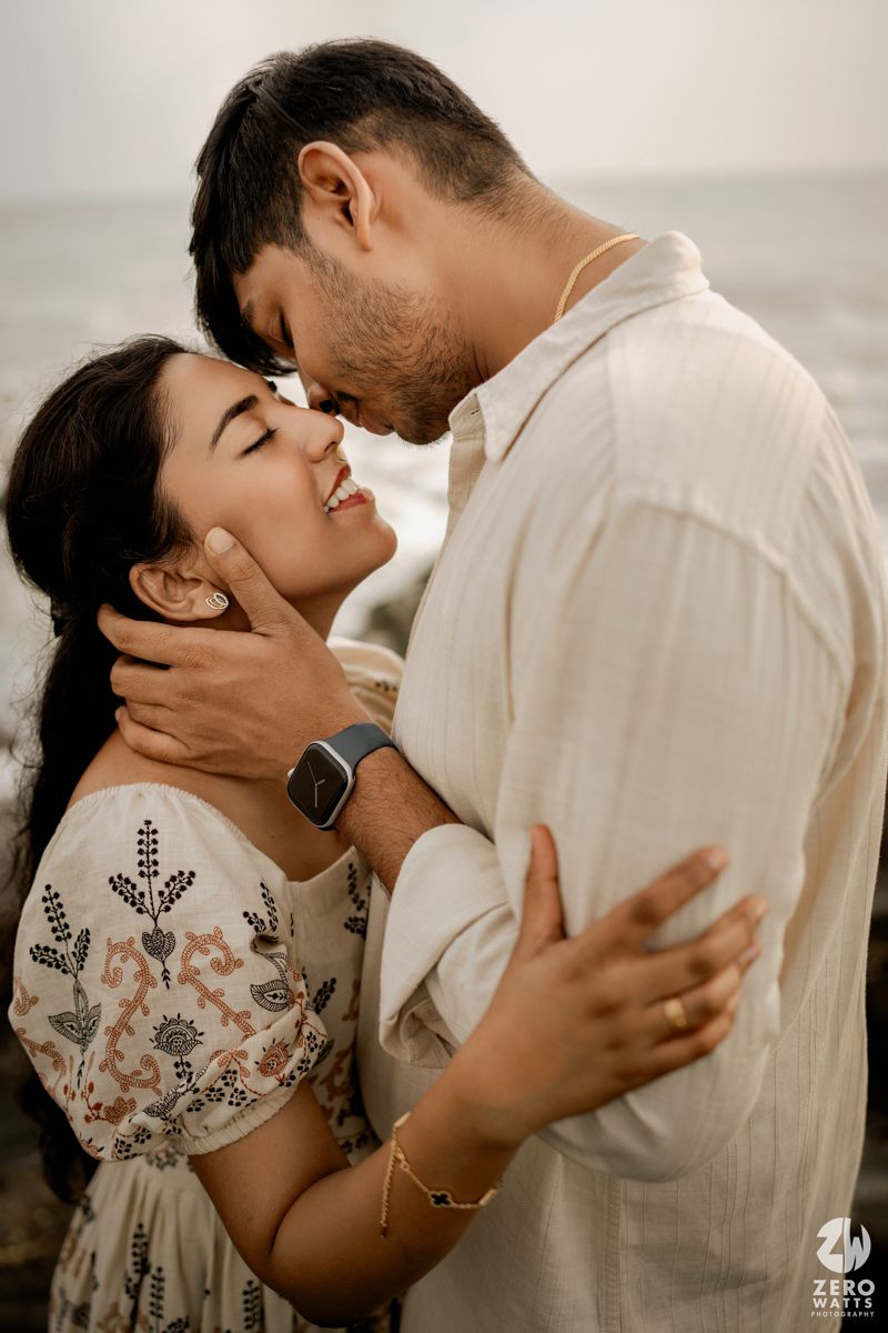 A romantic couple in white clothing share intimate moments in a series of tender embraces against a light background.
