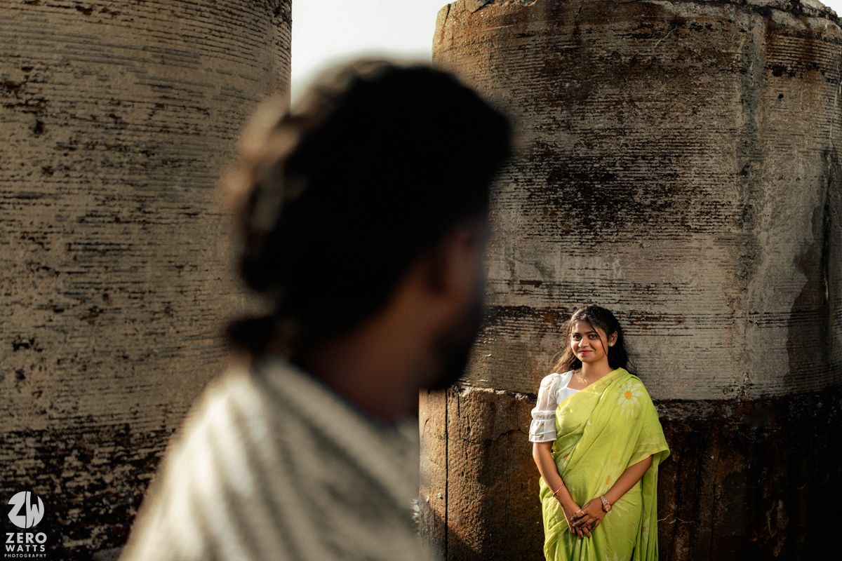 Artistic composition with couple posing at historic stone fortress.
