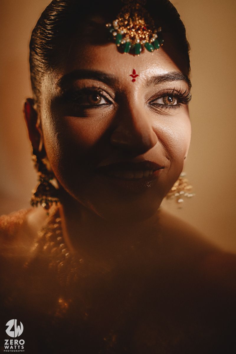 Artistic close-up portraits showing traditional Indian bridal makeup and jewelry in warm, moody lighting.