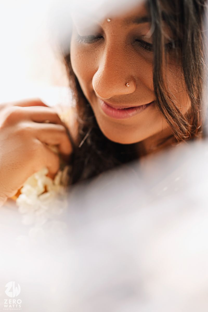 A close-up portrait series showing soft, dreamy angles of a person with dark hair and a nose piercing.