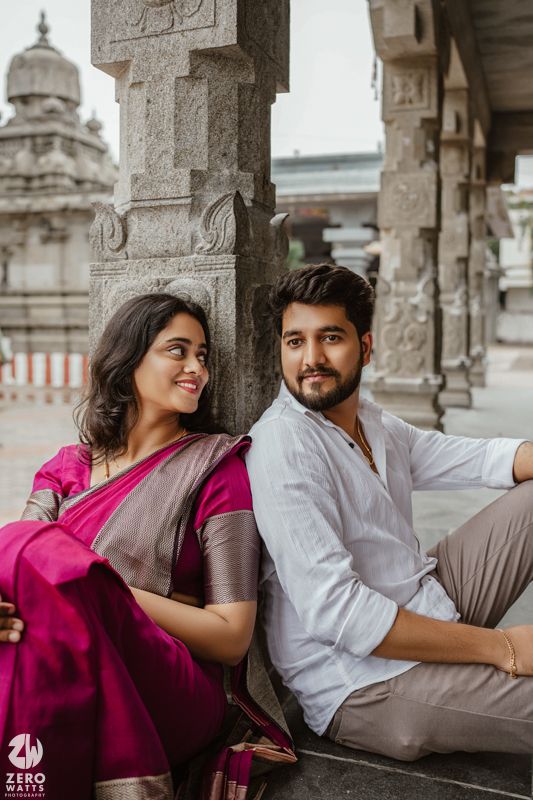 Romantic photoshoot in an ancient stone temple colonnade with traditional architecture.