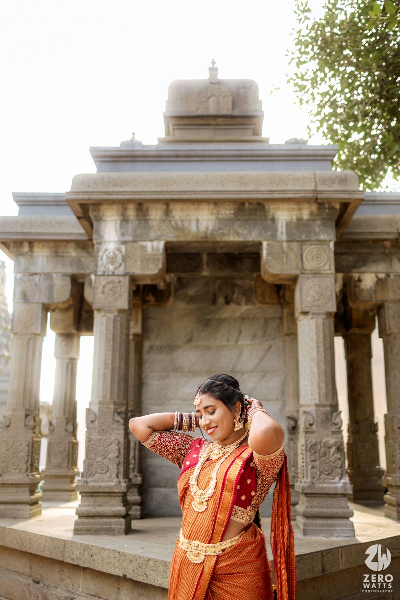 Ancient stone pillars and columns create a dramatic architectural corridor in a historic temple structure.
