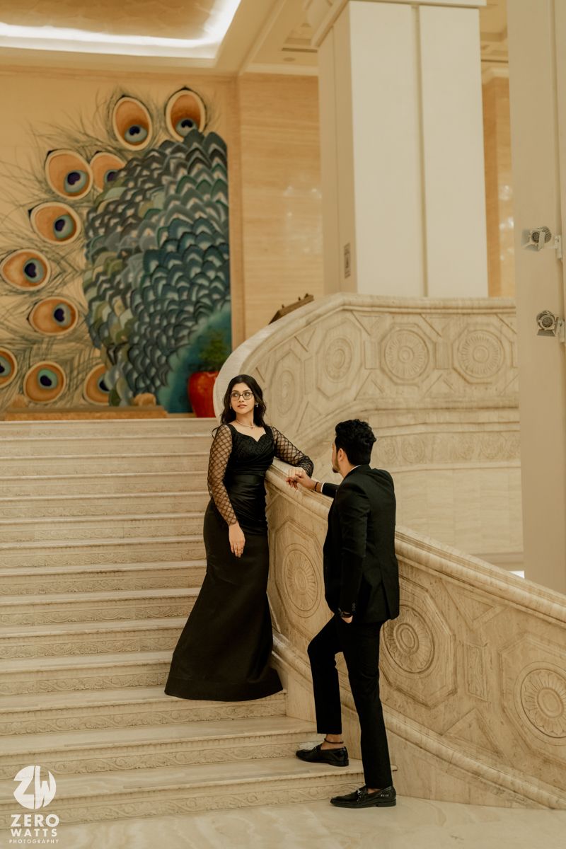 Artistic photoshoot in luxurious venue featuring peacock wall mural and elegant marble architecture.