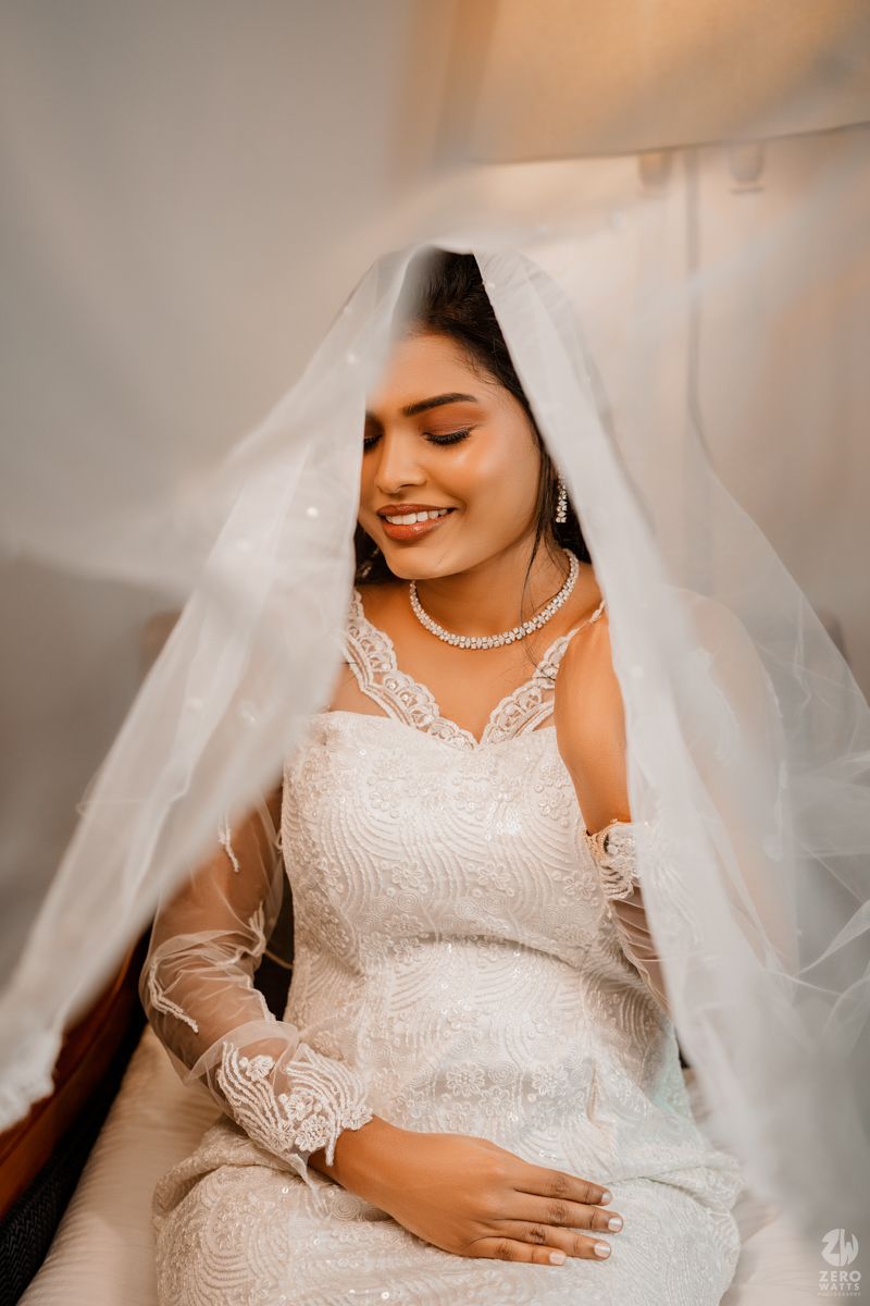 A bridal portrait series showing intricate details of a white lace wedding dress and flowing veil.
