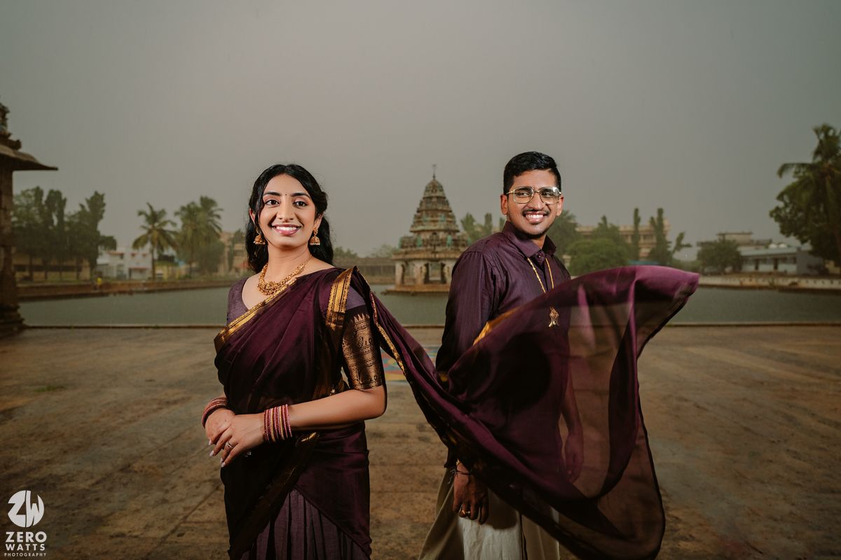 Couple's engagement session in traditional Indian attire against a scenic temple backdrop.