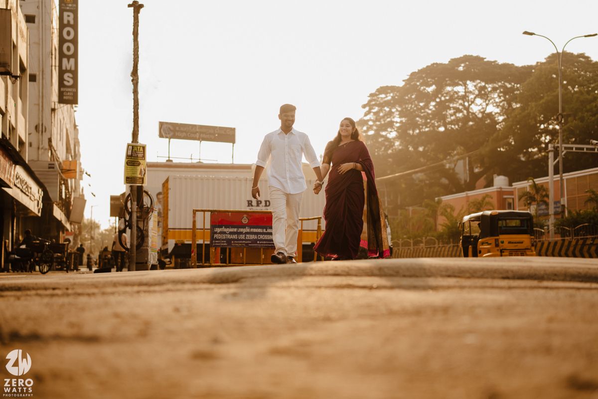 Silhouettes of people against the warm evening sky at a historic Mumbai landmark.