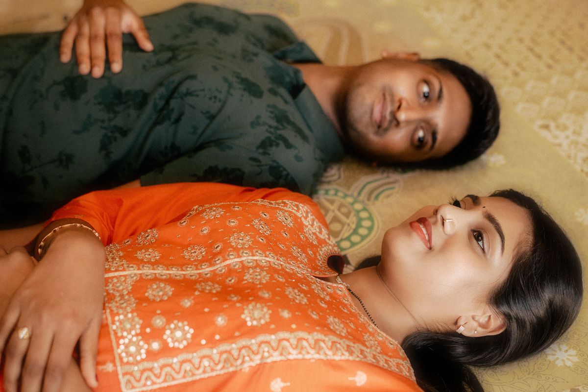 A sequence of six similar photos showing someone lying down in an orange floral dress against a beige background.